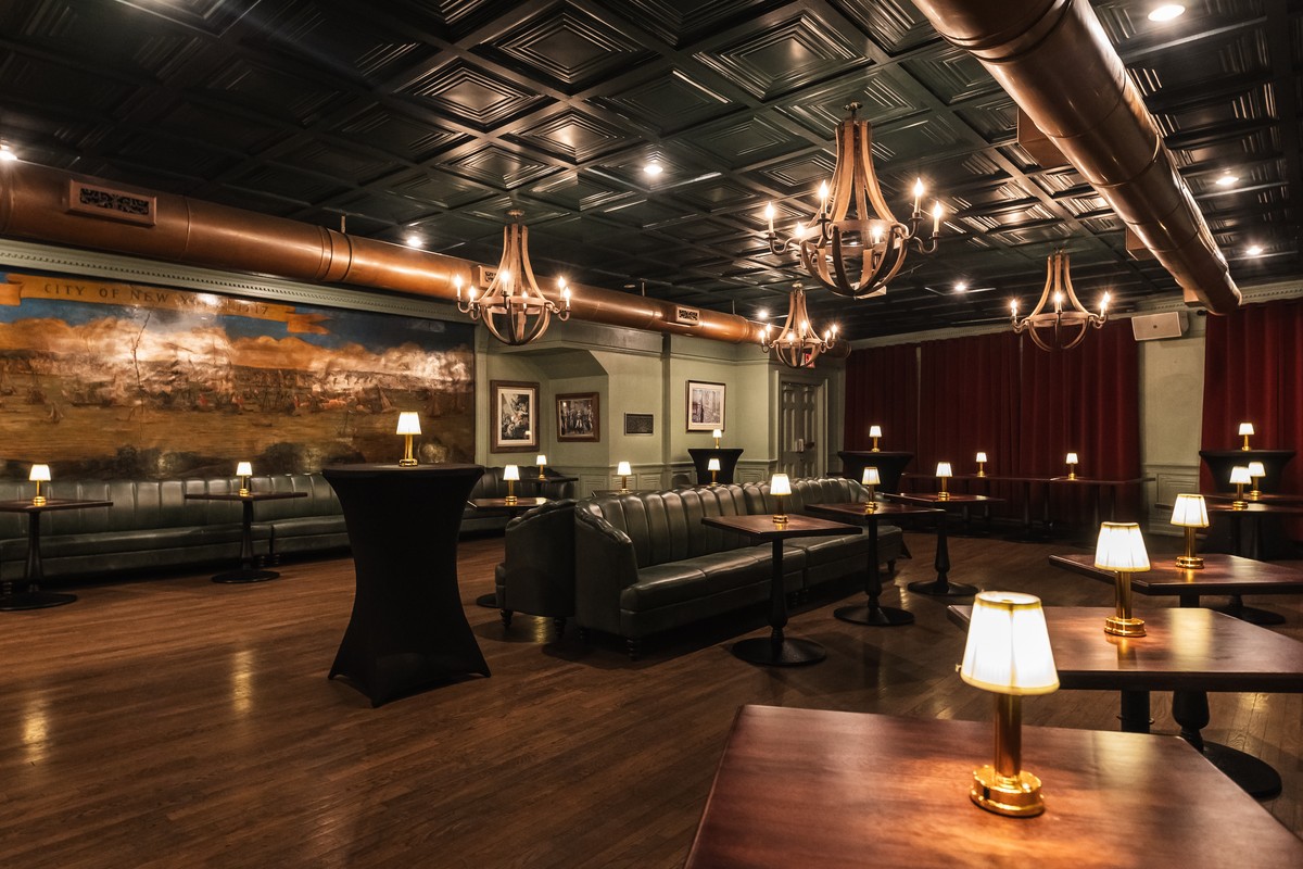 Elegant lounge with vintage train theme, featuring plush seating, dim table lamps, rich wood accents